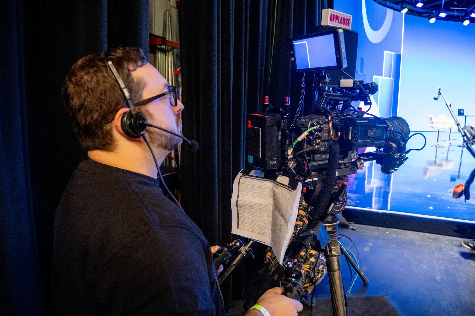 Production crew adjusting equipment on the Zoomtopia set